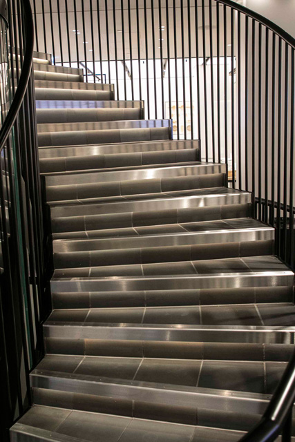 Stairs and handrails lit up. The handrails are stylishly painted black with synthetic resin paint.