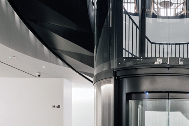 The corrugated ceiling of the spiral staircase forming a three dimensional curvature