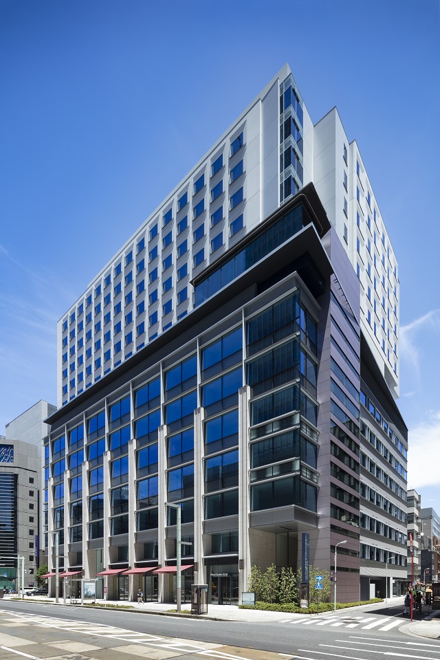 Right: Exterior of the elevator shaft is covered in reddish silver metallic painted aluminium panels