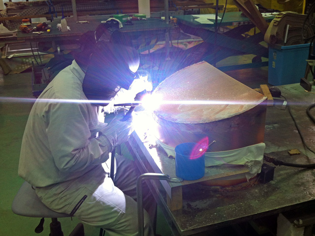 A Kikukawa craftsman carefully welding the copper pieces