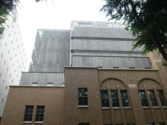 The zinc phosphate coated steel panels are in harmony with the restored low-rise section of the building