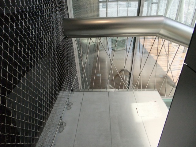 From the staircase landing, the clear view of the randomly placed suspension round bars is available.