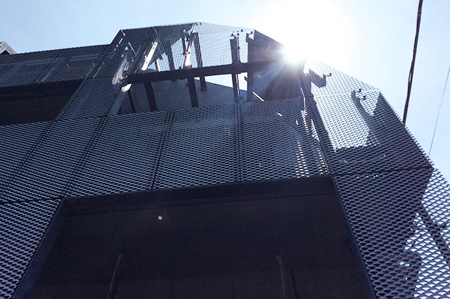 Expanded metal facade cut and installed in-line with the shape of the building.