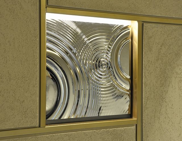 A metal relief panel installed in an apartment building entrance